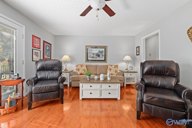12501 S Shawdee Rd SE, Huntsville, AL 35803 - living area with ceiling fan, light wood-style flooring, and a textured ceiling