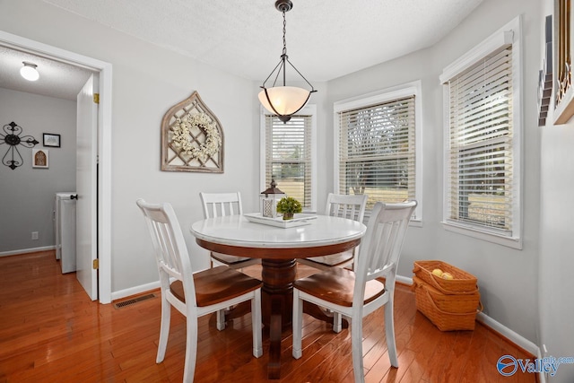 12501 S Shawdee Rd SE, Huntsville, AL 35803 - dining room featuring light wood finished floors, baseboards, and a textured ceiling