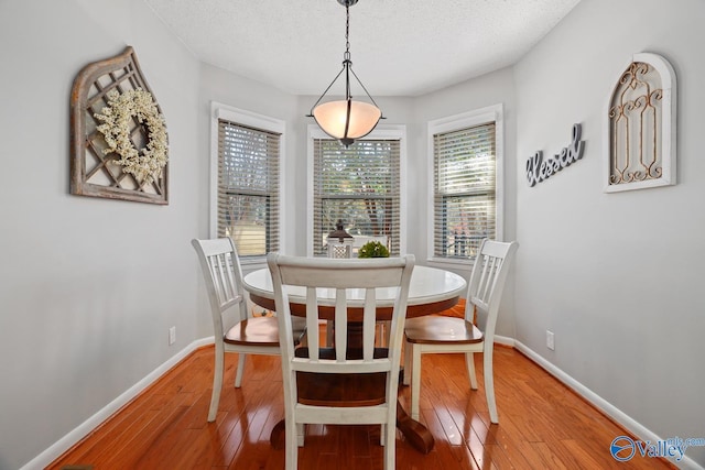 12501 S Shawdee Rd SE, Huntsville, AL 35803 - dining area featuring light wood-type flooring, baseboards, and a textured ceiling