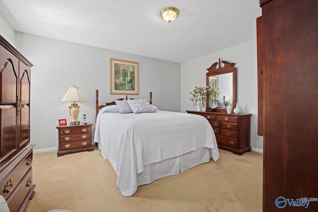 12501 S Shawdee Rd SE, Huntsville, AL 35803 - bedroom featuring light carpet and a textured ceiling