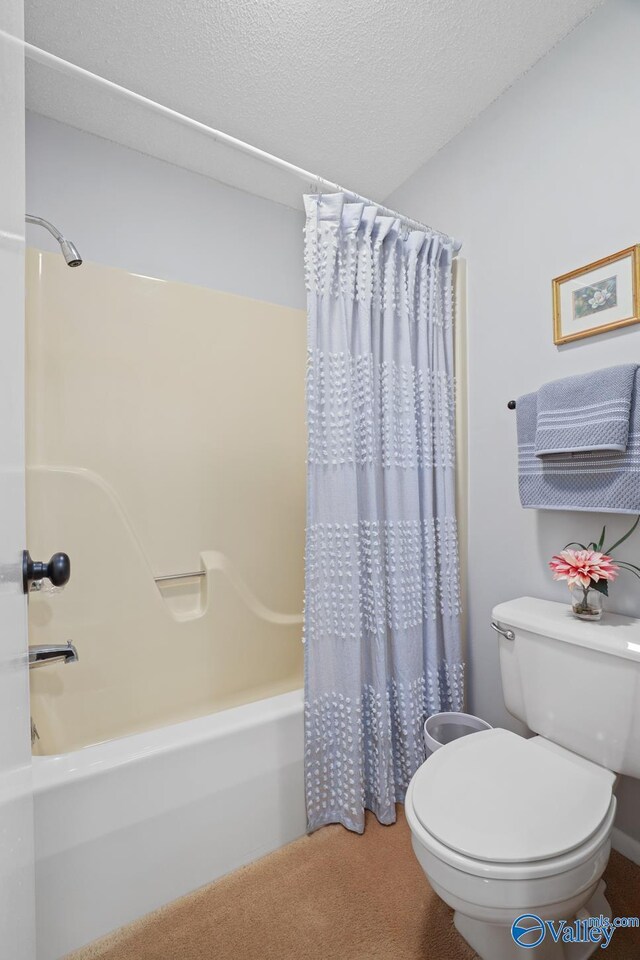 12501 S Shawdee Rd SE, Huntsville, AL 35803 - full bathroom featuring shower / bathtub combination with curtain, toilet, and a textured ceiling
