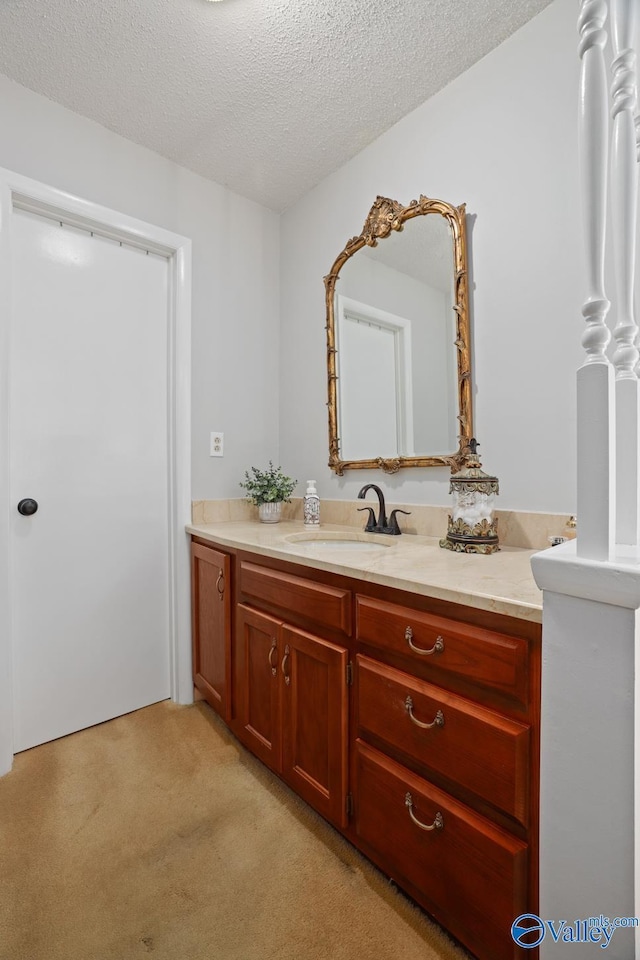 12501 S Shawdee Rd SE, Huntsville, AL 35803 - bathroom featuring a textured ceiling, vanity, and carpet floors