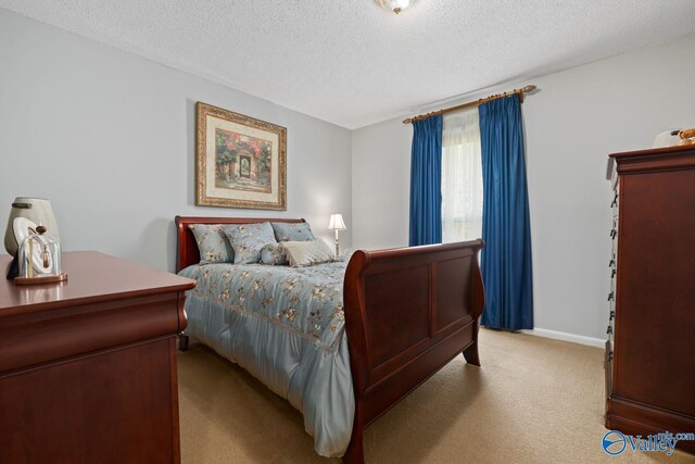 12501 S Shawdee Rd SE, Huntsville, AL 35803 - bedroom with light carpet, a textured ceiling, and baseboards