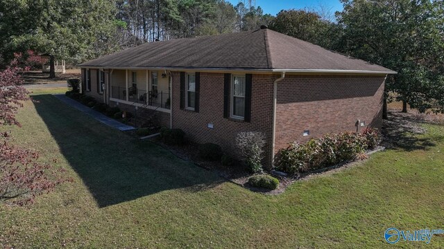 12501 S Shawdee Rd SE, Huntsville, AL 35803 - view of side of home with a lawn, brick siding, covered porch, and a shingled roof