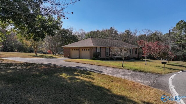 12501 S Shawdee Rd SE, Huntsville, AL 35803 - view of front facade featuring a front yard, asphalt driveway, a garage, and brick siding