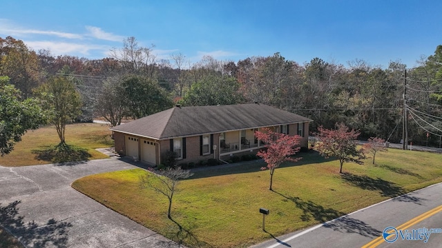 12501 S Shawdee Rd SE, Huntsville, AL 35803 - view of front of home with a porch, driveway, a front yard, an attached garage, and a forest view