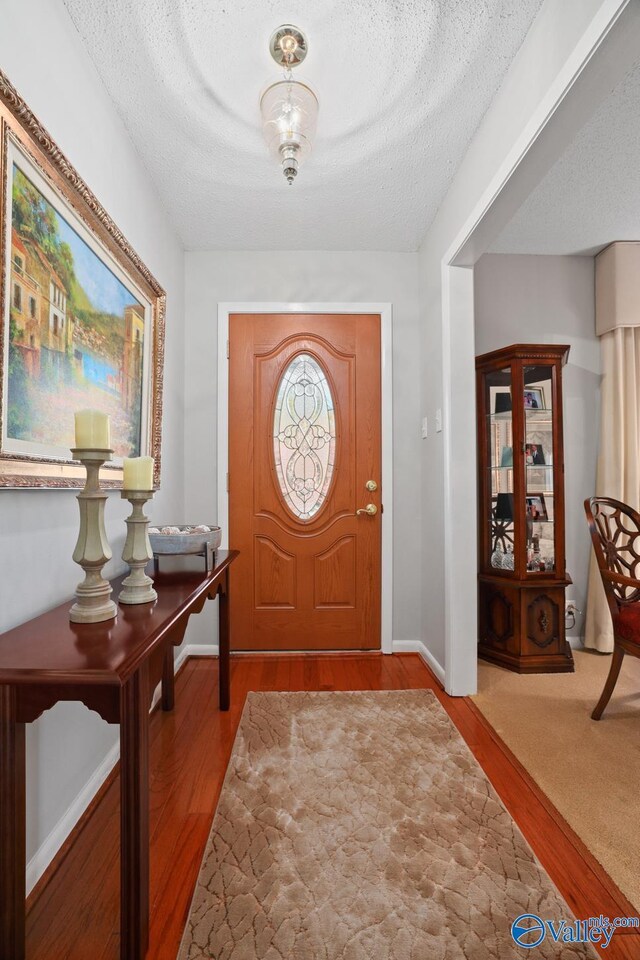 12501 S Shawdee Rd SE, Huntsville, AL 35803 - entryway with wood finished floors, a textured ceiling, and baseboards