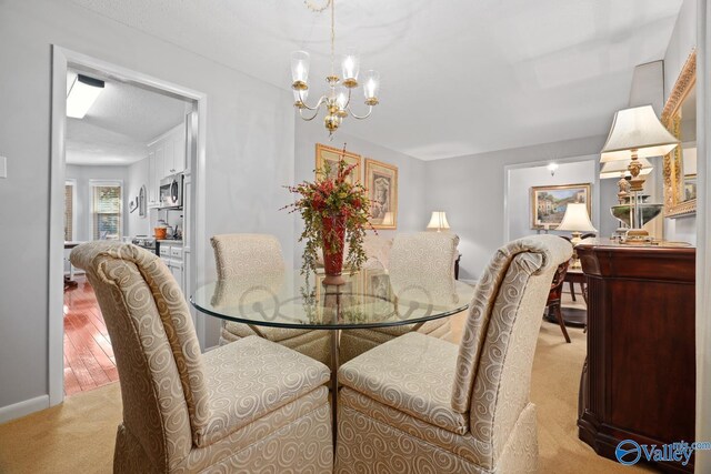 12501 S Shawdee Rd SE, Huntsville, AL 35803 - dining room featuring light colored carpet and a chandelier