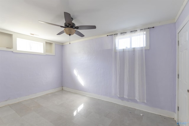 unfurnished room with a ceiling fan, baseboards, and visible vents