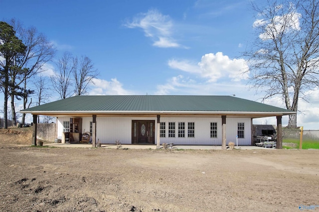 view of front of home featuring driveway and metal roof