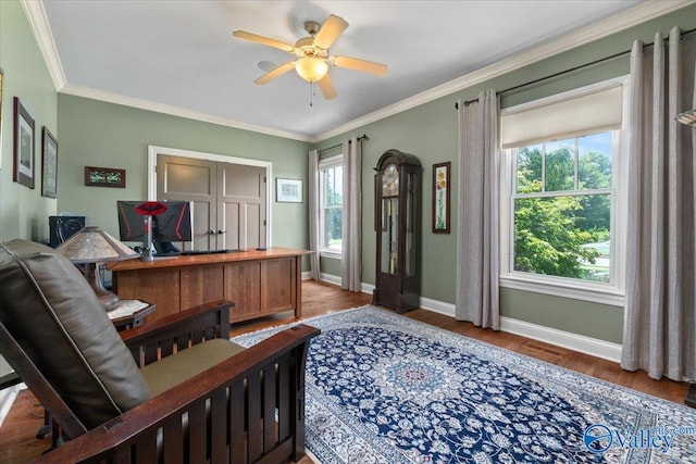 home office with ceiling fan, crown molding, and hardwood / wood-style flooring