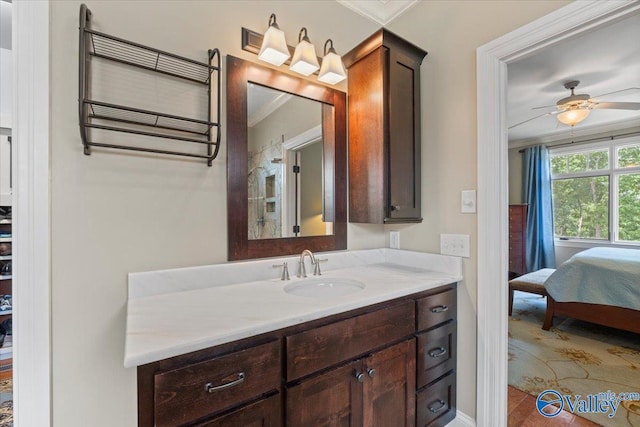 bathroom with a ceiling fan, vanity, ensuite bath, and ornamental molding
