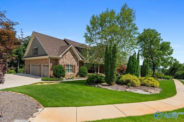 view of front of house with driveway, stone siding, a front lawn, brick siding, and a garage