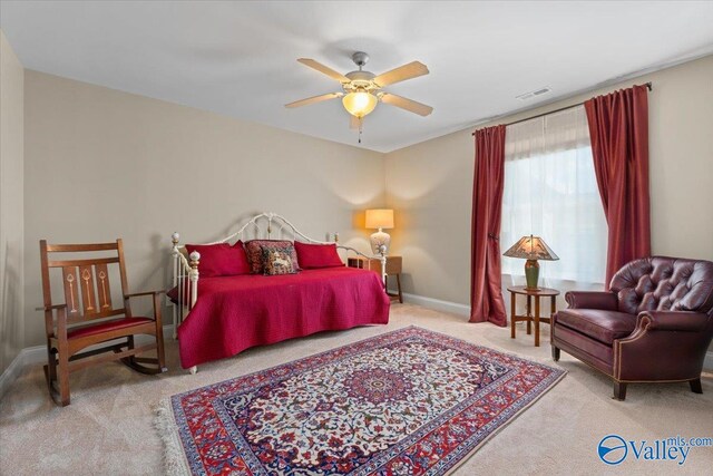 bedroom featuring light colored carpet and ceiling fan