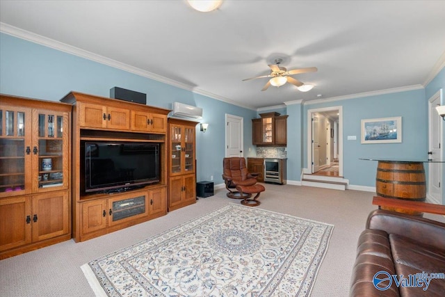 living area with a wall mounted air conditioner, carpet, a ceiling fan, and ornamental molding