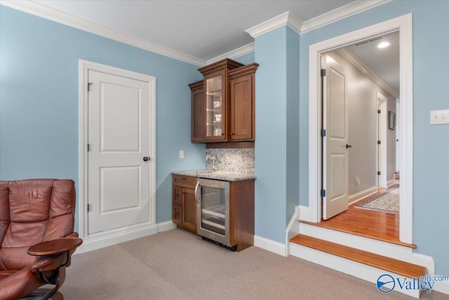 bar featuring ornamental molding, a dry bar, wine cooler, decorative backsplash, and light carpet