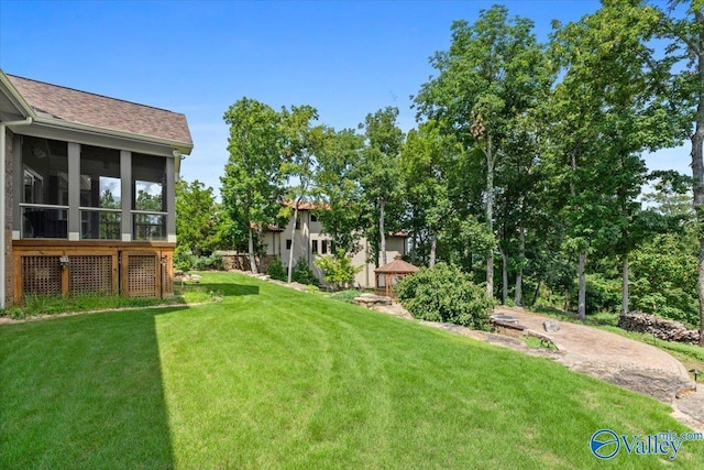 view of yard with a sunroom