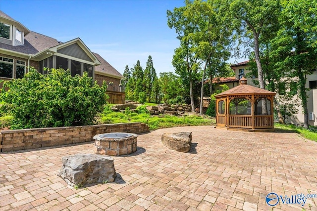 view of patio featuring a gazebo and a fire pit