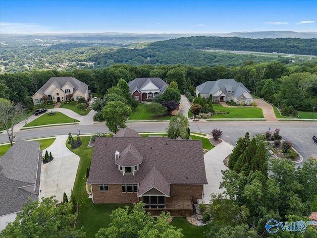 drone / aerial view with a residential view and a forest view