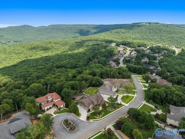 drone / aerial view with a forest view, a mountain view, and a residential view