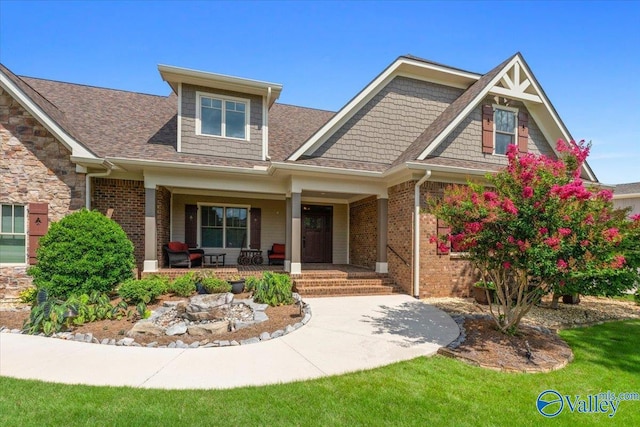craftsman inspired home with brick siding and covered porch