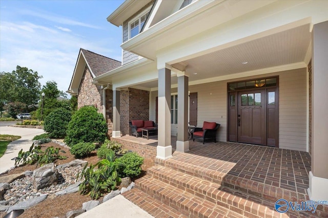 view of exterior entry with a porch