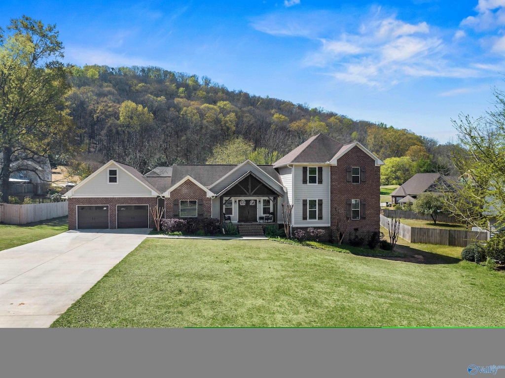 view of front of property featuring a front yard and a garage