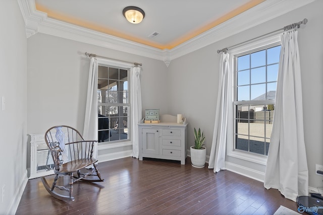 living area featuring ornamental molding and dark hardwood / wood-style floors