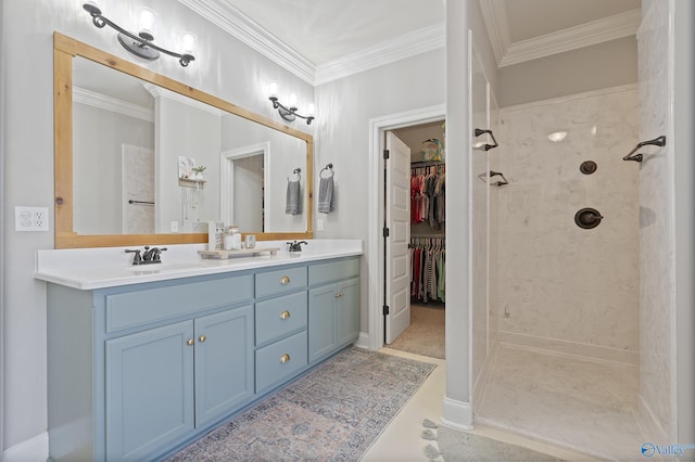 bathroom with ornamental molding, vanity, and a tile shower