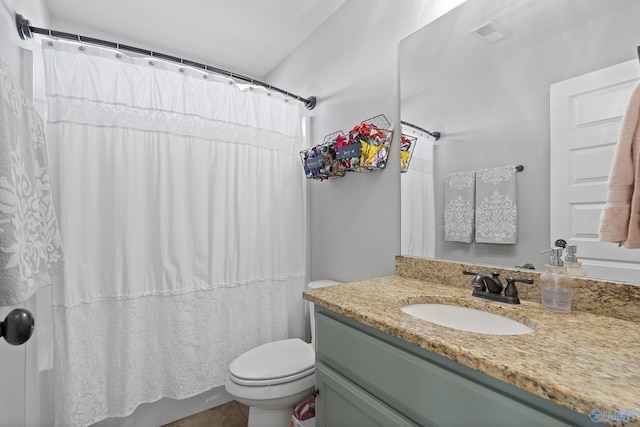 bathroom featuring vanity, toilet, and walk in shower