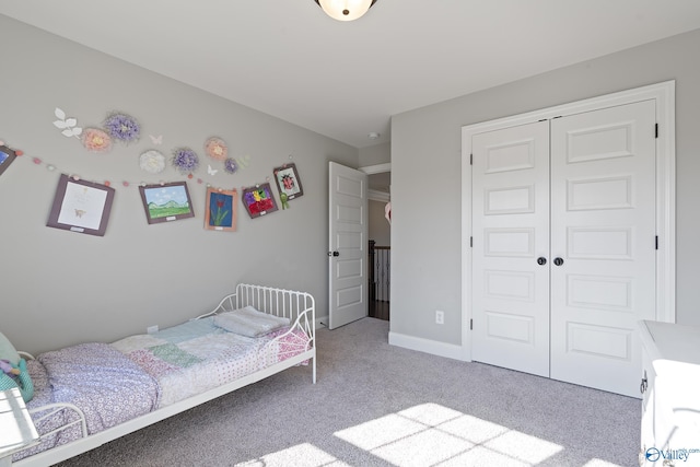 bedroom featuring light colored carpet and a closet