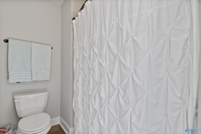 bathroom featuring tile patterned floors and toilet