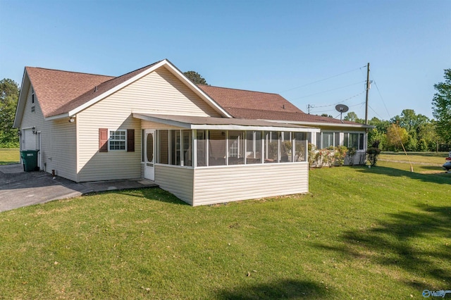 25 County Road 504, Centre, AL 35960 - rear view of house with a sunroom, a shingled roof, and a lawn