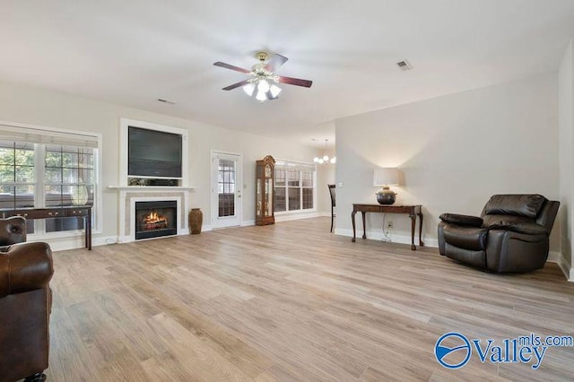 25 County Road 504, Centre, AL 35960 - living area featuring plenty of natural light, visible vents, light wood-type flooring, and ceiling fan with notable chandelier