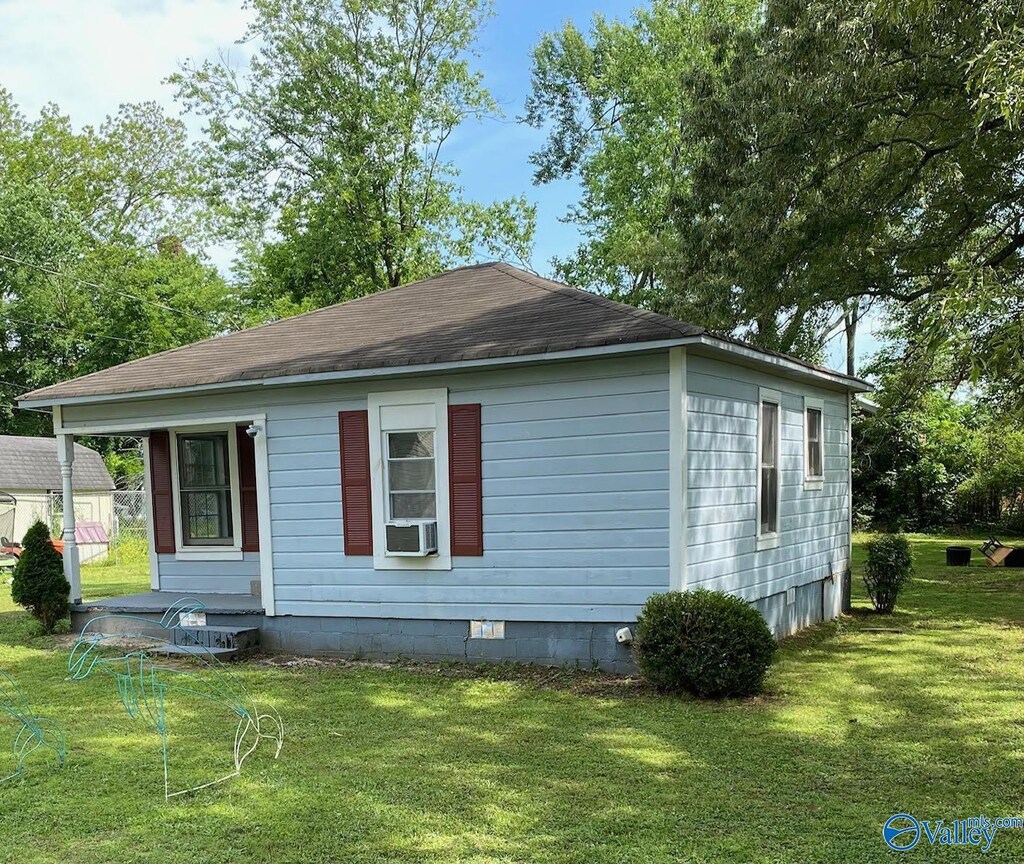410 Ponroy St, Scottsboro, AL 35768 - view of property exterior featuring a lawn, cooling unit, and crawl space