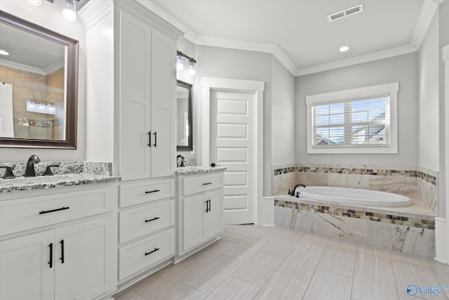 bathroom with a relaxing tiled tub, a sink, visible vents, ornamental molding, and double vanity