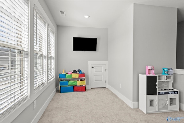 recreation room with light carpet, visible vents, baseboards, and recessed lighting