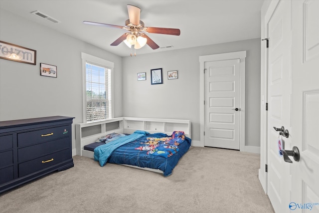 bedroom featuring a ceiling fan, visible vents, light carpet, and baseboards