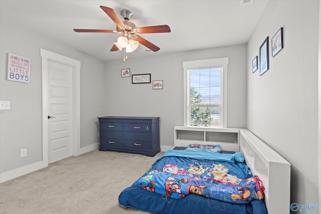 bedroom with ceiling fan, baseboards, and light colored carpet