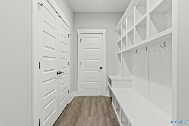 mudroom with dark wood finished floors