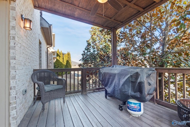 wooden terrace featuring ceiling fan and area for grilling