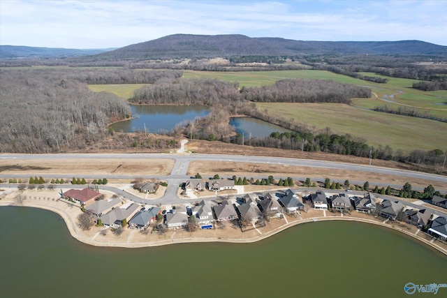 drone / aerial view featuring a residential view and a water and mountain view