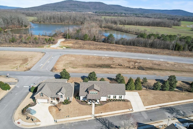 birds eye view of property featuring a water and mountain view