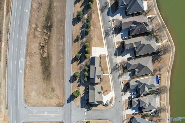 bird's eye view with a residential view and a water view