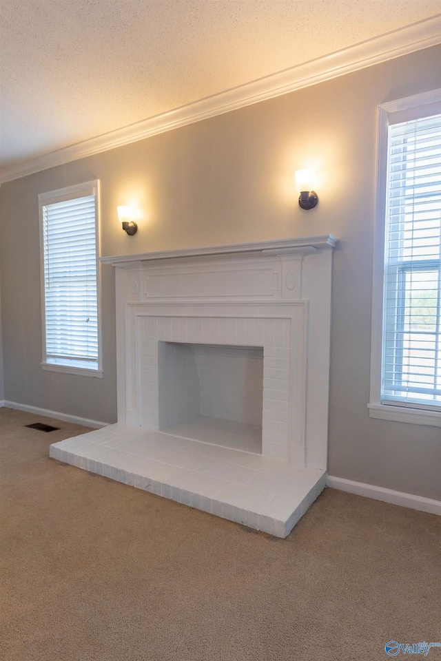 details featuring ornamental molding, carpet flooring, a brick fireplace, and a textured ceiling