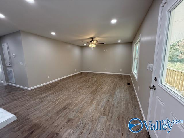 unfurnished room with dark wood-type flooring