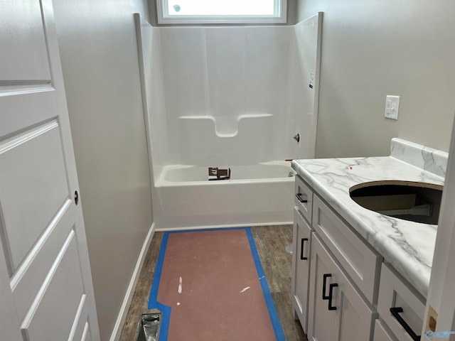 bathroom featuring shower / tub combination, vanity, and hardwood / wood-style flooring