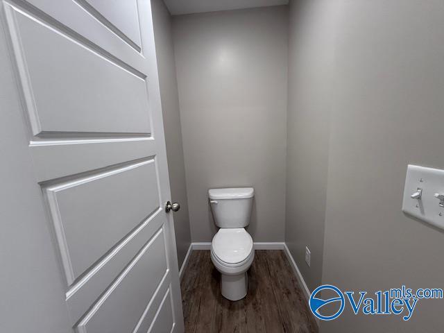 laundry room with hookup for a washing machine, dark wood-type flooring, and electric dryer hookup