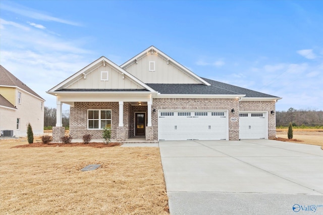 craftsman inspired home featuring a front yard, a garage, and cooling unit