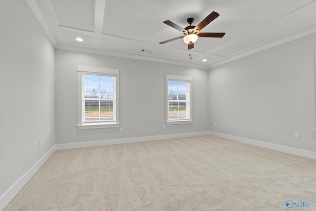 empty room with light colored carpet, crown molding, and a wealth of natural light